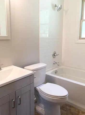 a bathroom with a sink a toilet and bathtub