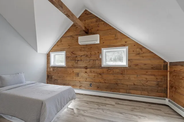 a bedroom with a bed and a wall painting