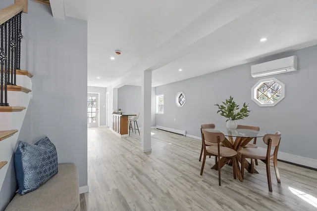 a dining room with furniture and wooden floor
