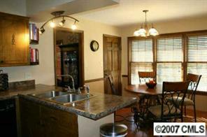 4083 Lake Shore Road South Denver, NC 28037 - Photo 3 of 8 a view of a dining room with furniture and chandelier
