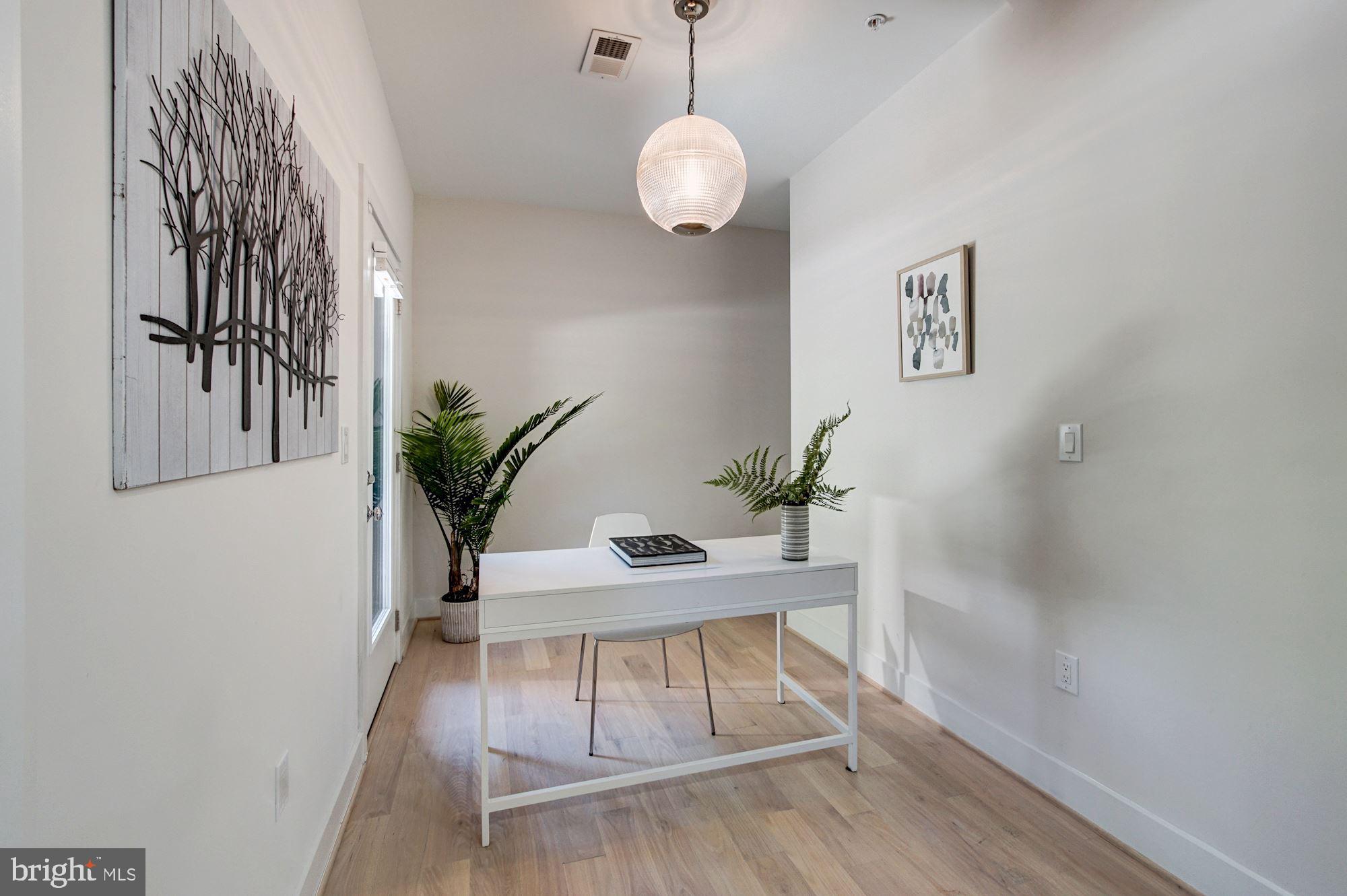 1352 Quincy Street Northwest, Unit 1 Washington, DC 20011 - Photo 10 of 26 a view of a room with wooden floor and a potted plant