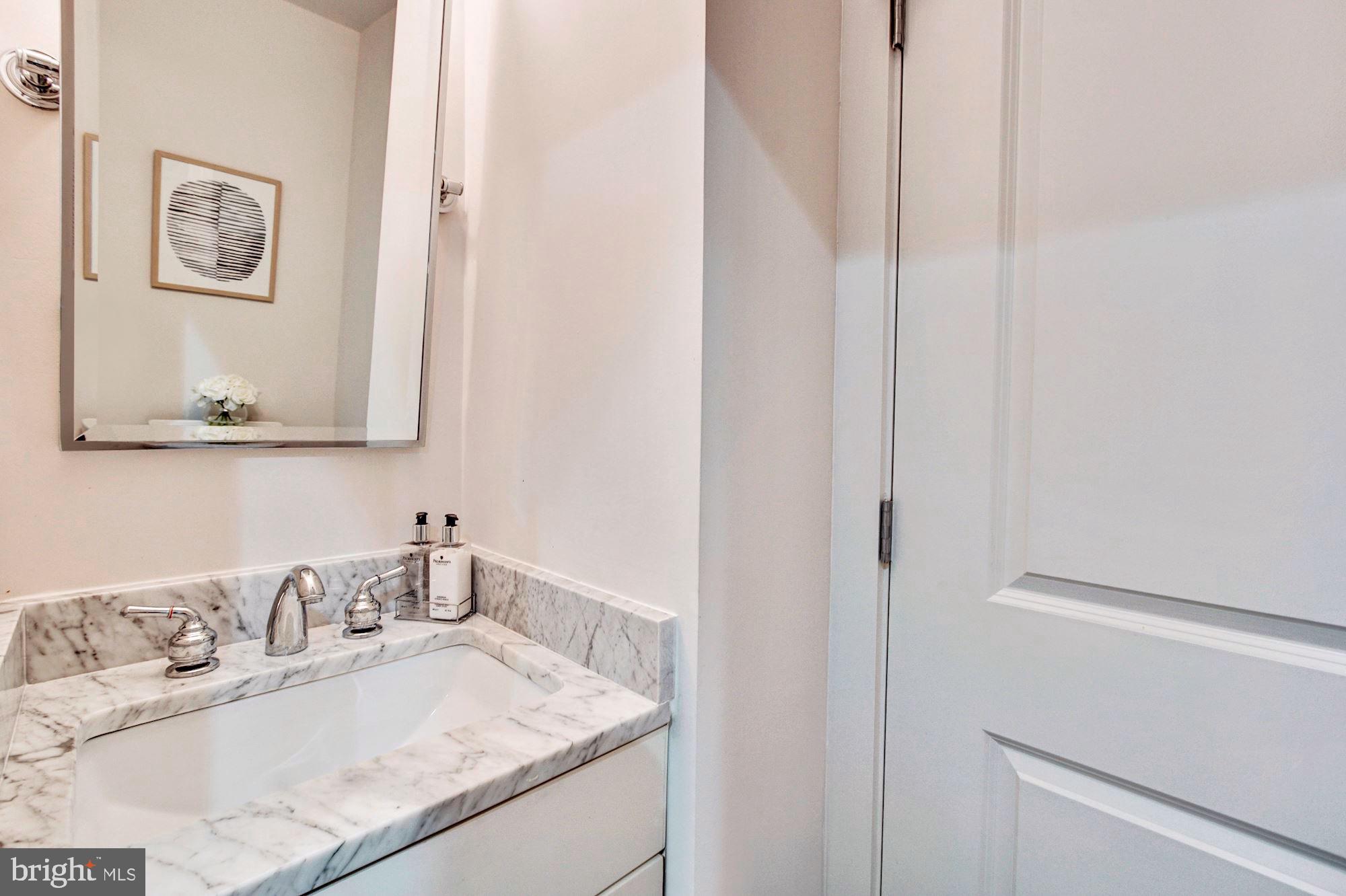 1352 Quincy Street Northwest, Unit 1 Washington, DC 20011 - Photo 12 of 26 a bathroom with a granite countertop sink and a mirror