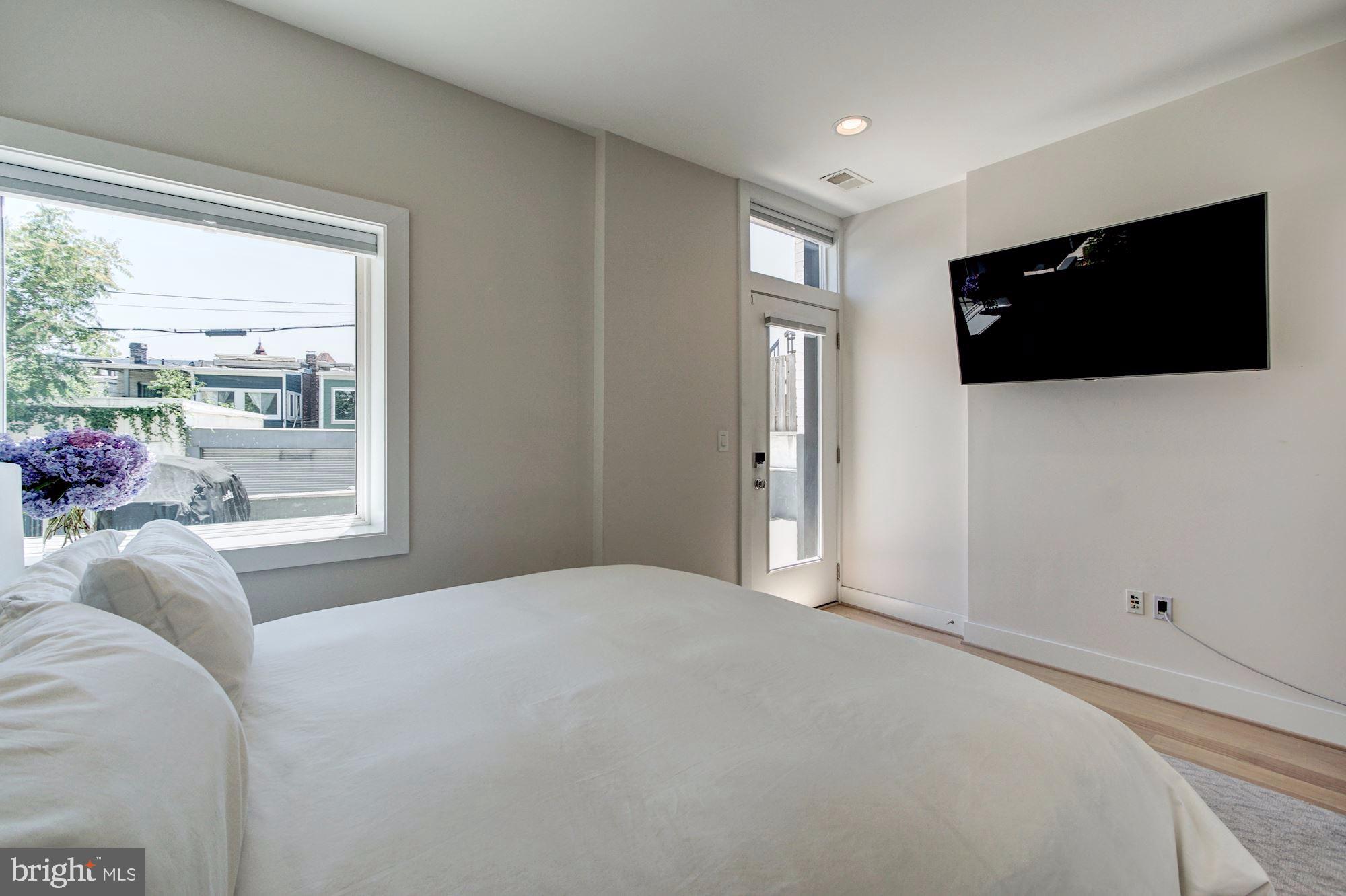 1352 Quincy Street Northwest, Unit 1 Washington, DC 20011 - Photo 16 of 26 a bedroom with a bed and a flat screen tv