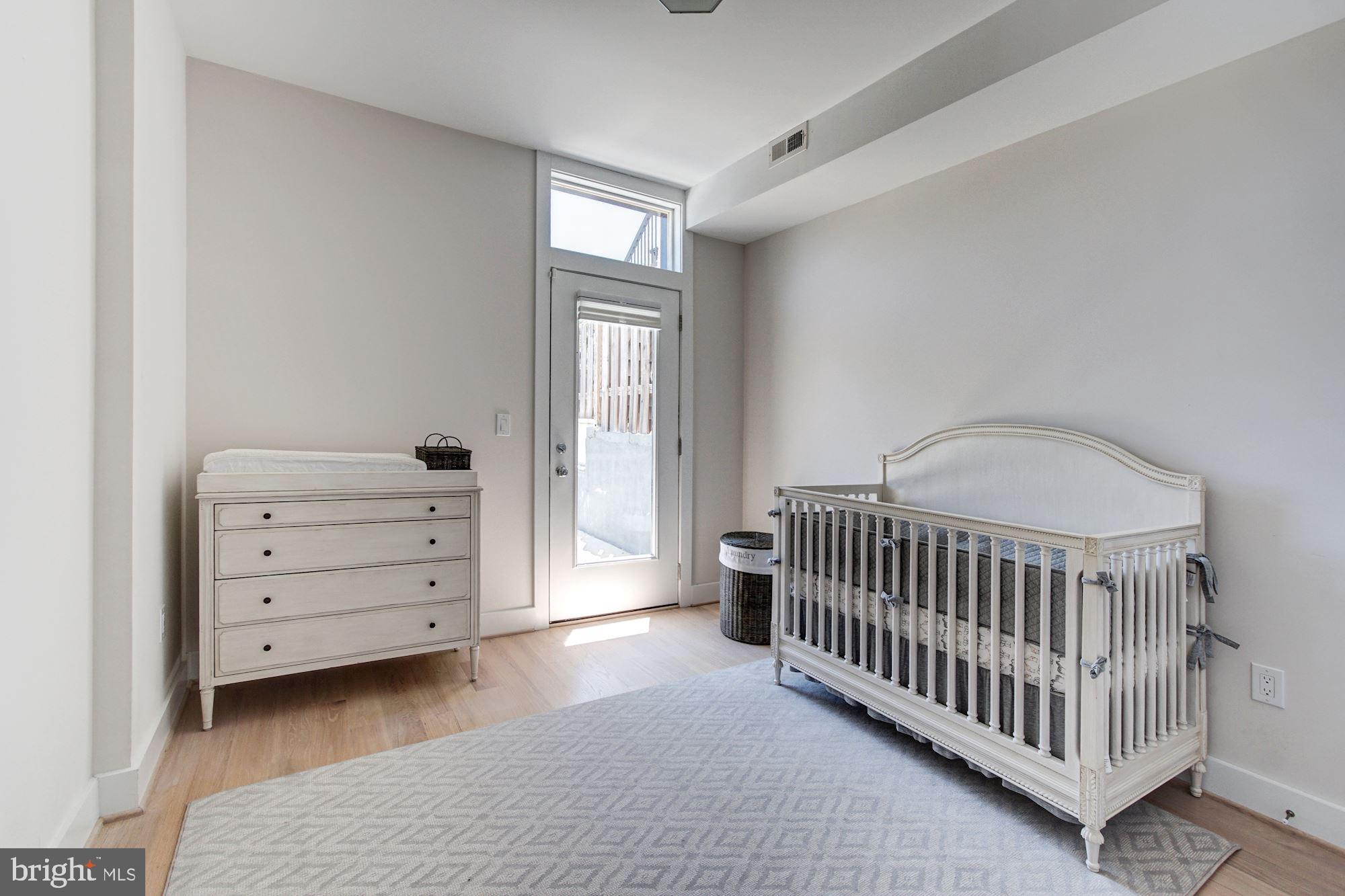 1352 Quincy Street Northwest, Unit 1 Washington, DC 20011 - Photo 18 of 26 a bedroom with a bed and a window