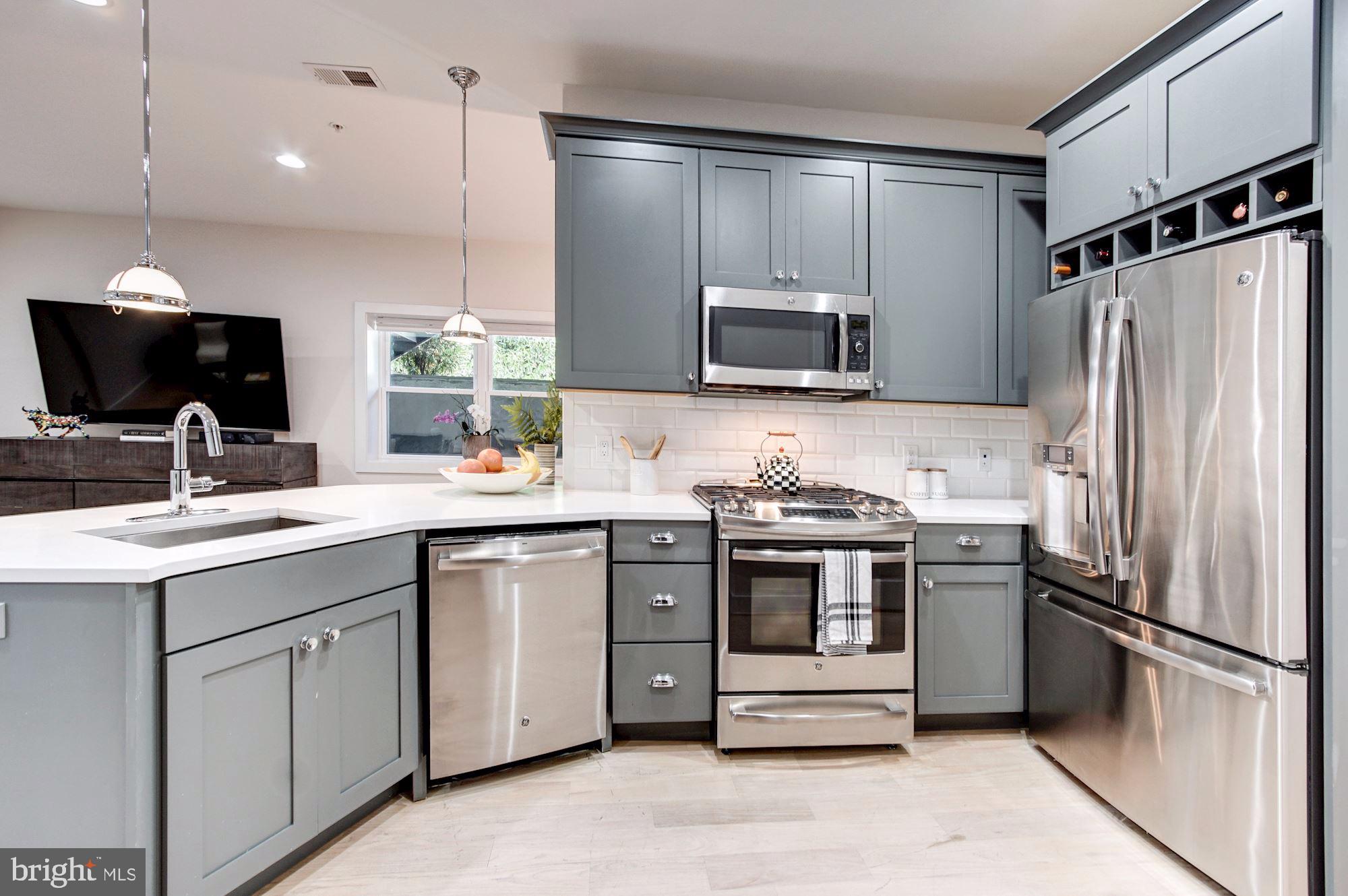 1352 Quincy Street Northwest, Unit 1 Washington, DC 20011 - Photo 6 of 26 a kitchen with a sink stainless steel appliances and cabinets
