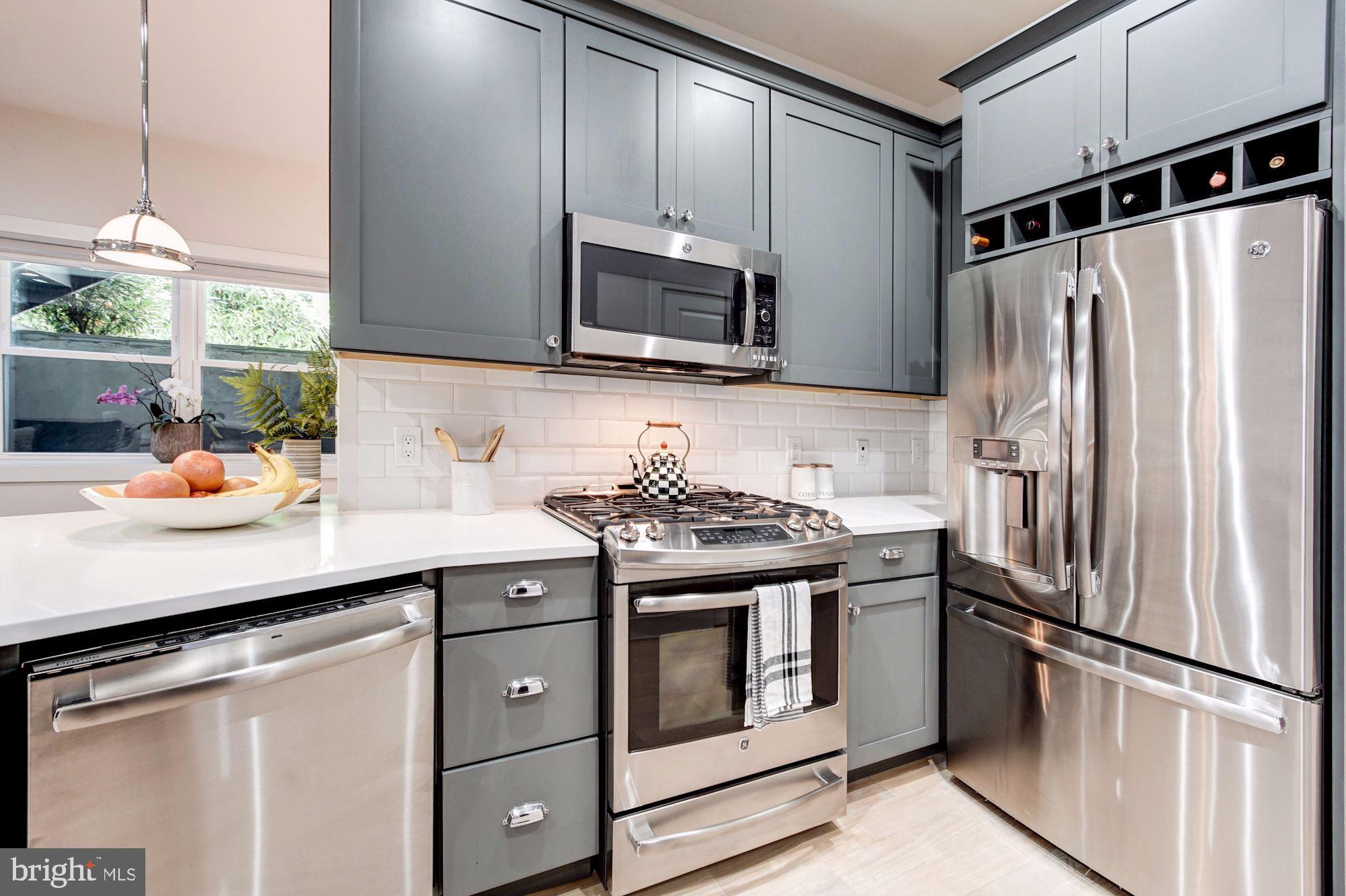 1352 Quincy Street Northwest, Unit 1 Washington, DC 20011 - Photo 7 of 26 a kitchen with stainless steel appliances a sink stove and refrigerator