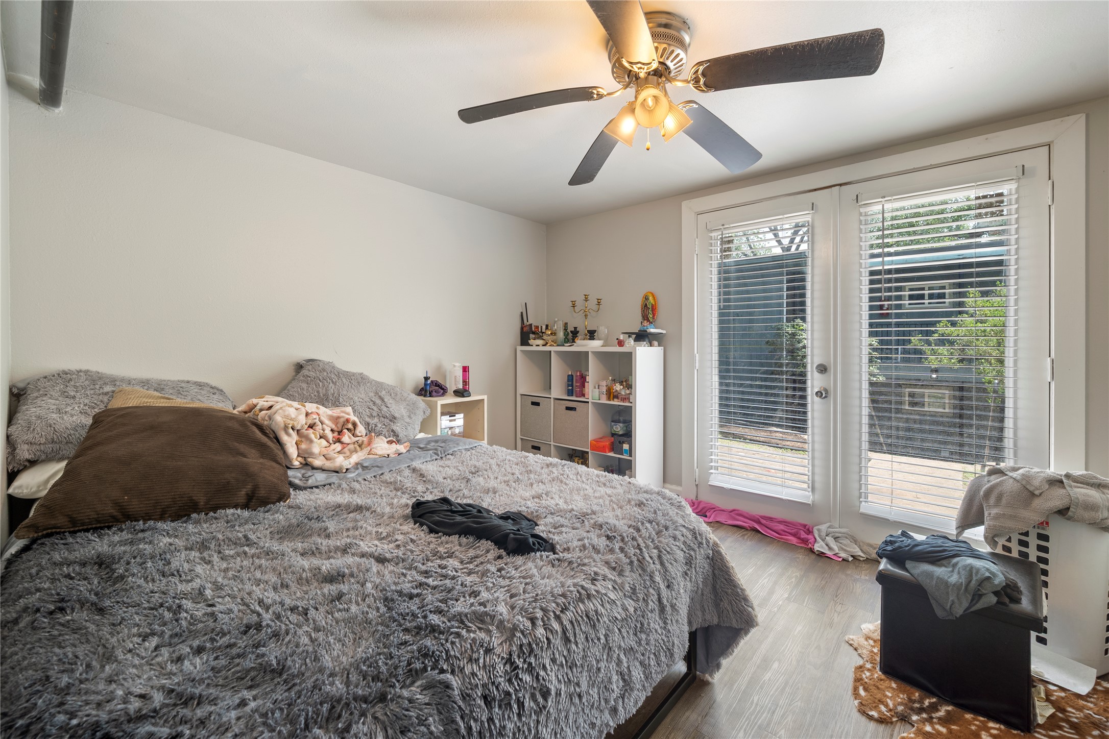201 West 31st Street, Unit E Austin, TX 78705 - Photo 4 of 16 Patio doors and wood-look flooring enhance this inviting bedroom's appeal.