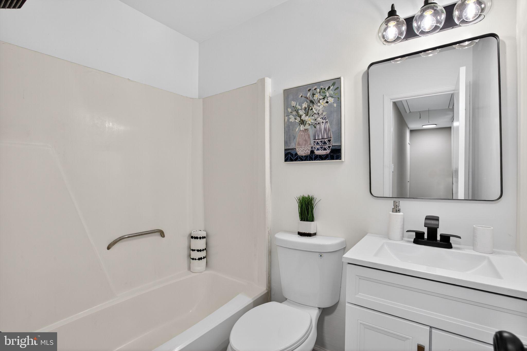 3278 Ryon Court Waldorf, MD 20601 - Photo 16 of 29 a bathroom with a toilet sink vanity tub and mirror