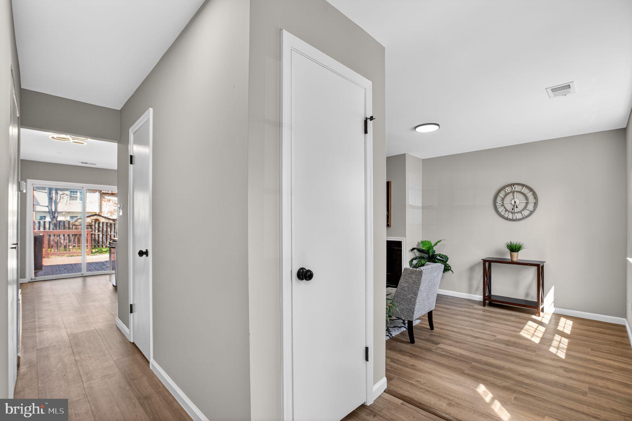 3278 Ryon Court Waldorf, MD 20601 - Photo 21 of 29 a view of a hallway with wooden floor and living room