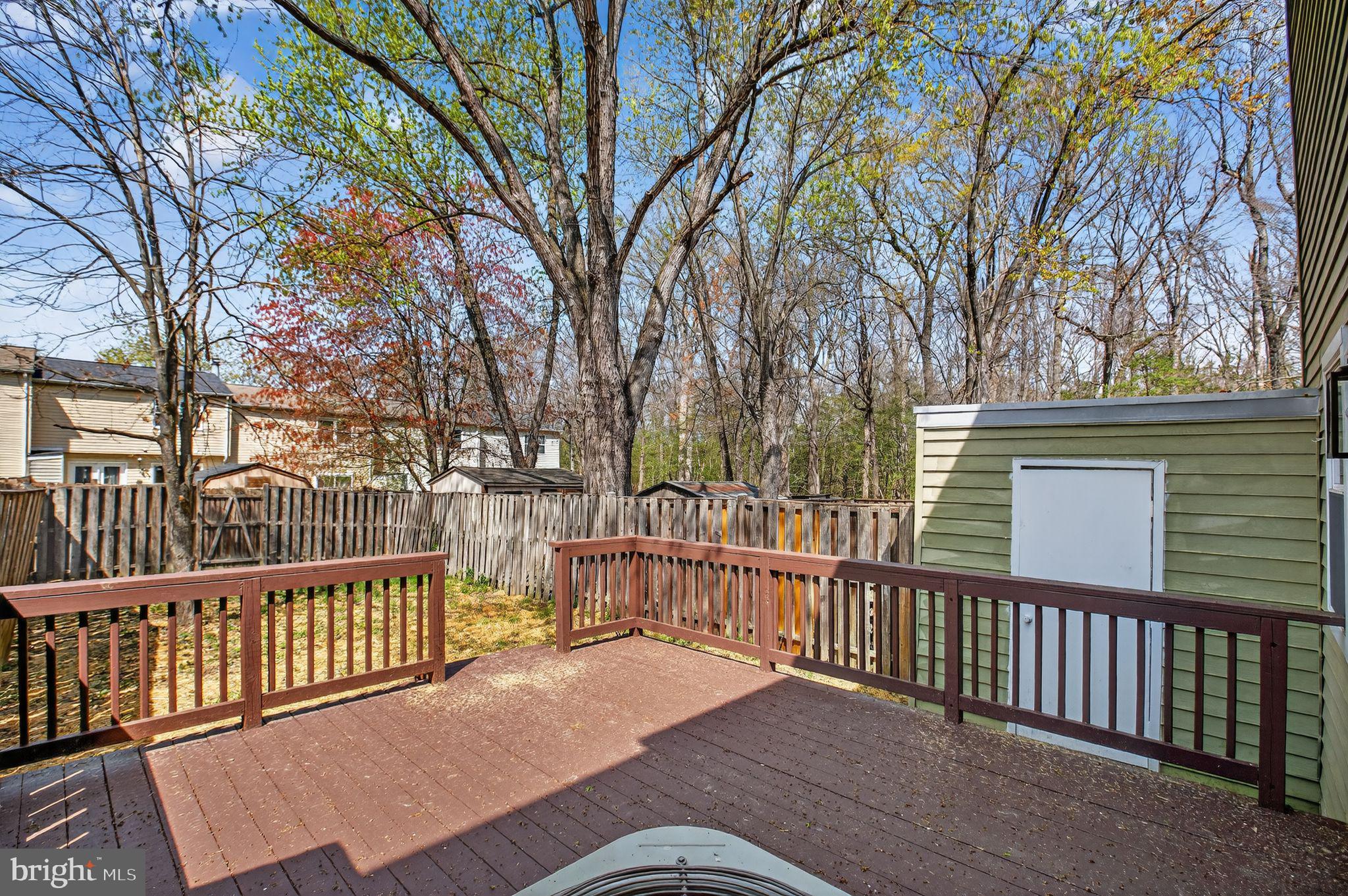 3278 Ryon Court Waldorf, MD 20601 - Photo 26 of 29 a view of a brick house with large trees and wooden fence
