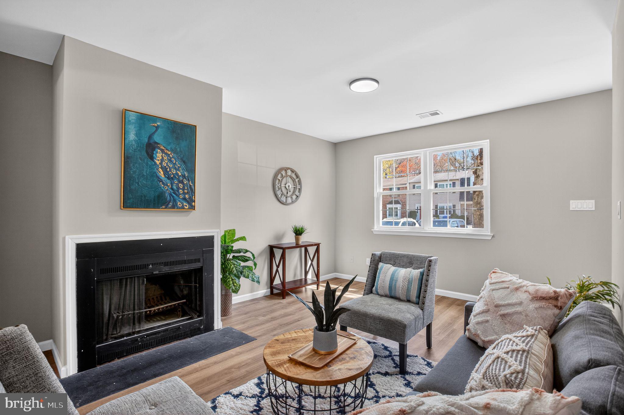 3278 Ryon Court Waldorf, MD 20601 - Photo 4 of 29 a living room with furniture a fireplace and a large mirror