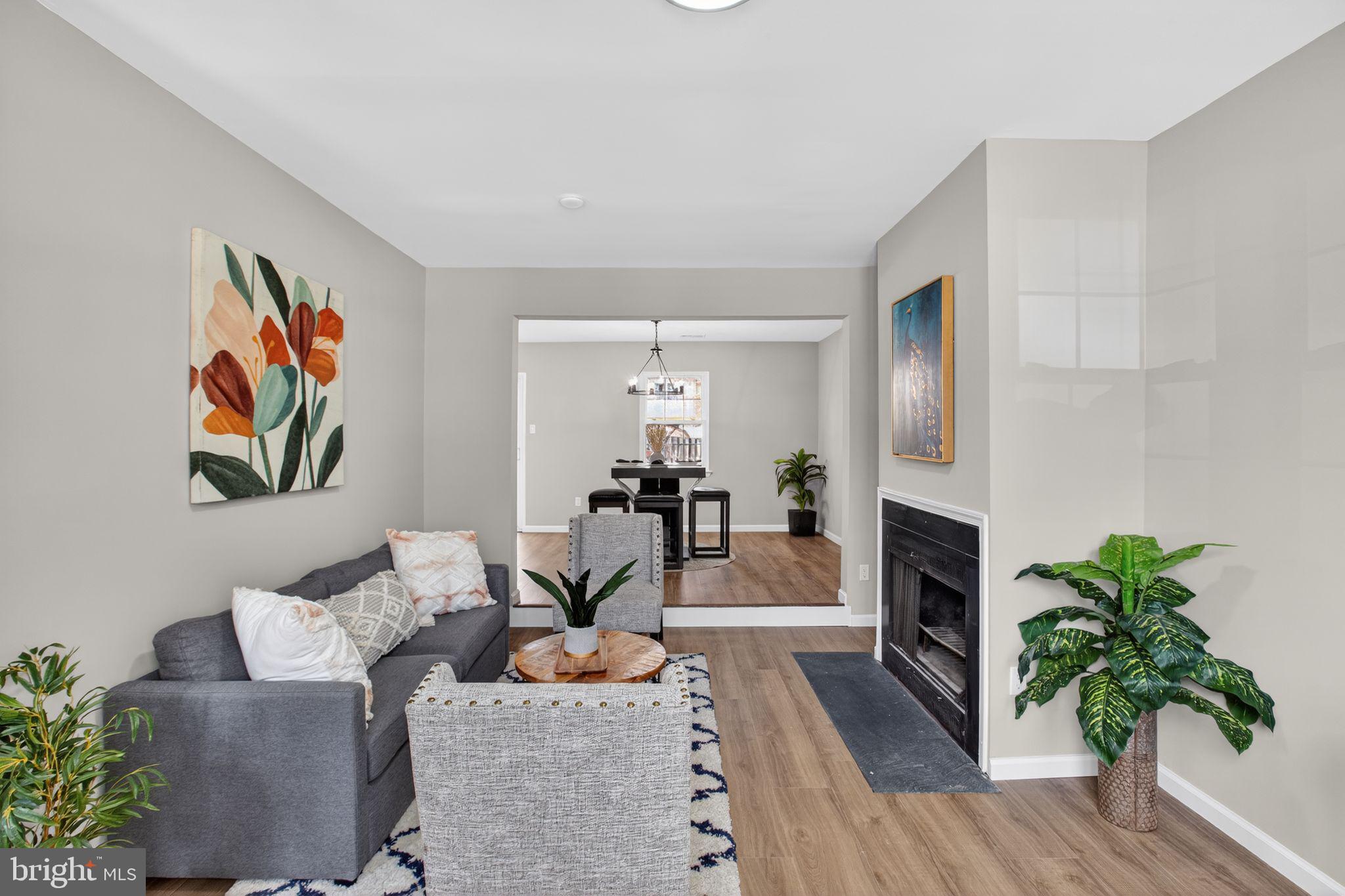3278 Ryon Court Waldorf, MD 20601 - Photo 5 of 29 a living room with furniture a fireplace and a potted plant