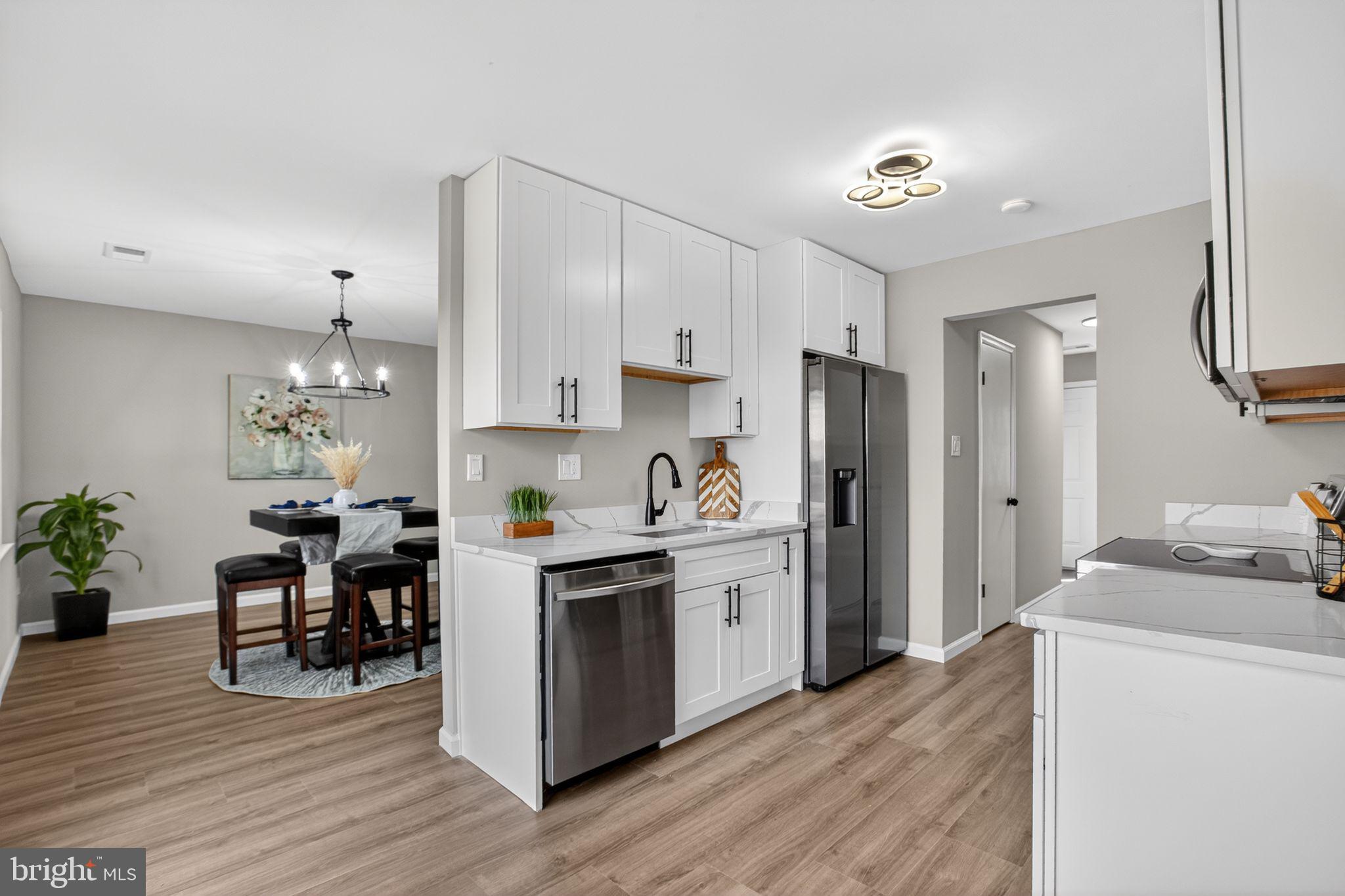 3278 Ryon Court Waldorf, MD 20601 - Photo 9 of 29 a kitchen with kitchen island granite countertop a sink cabinets and stainless steel appliances