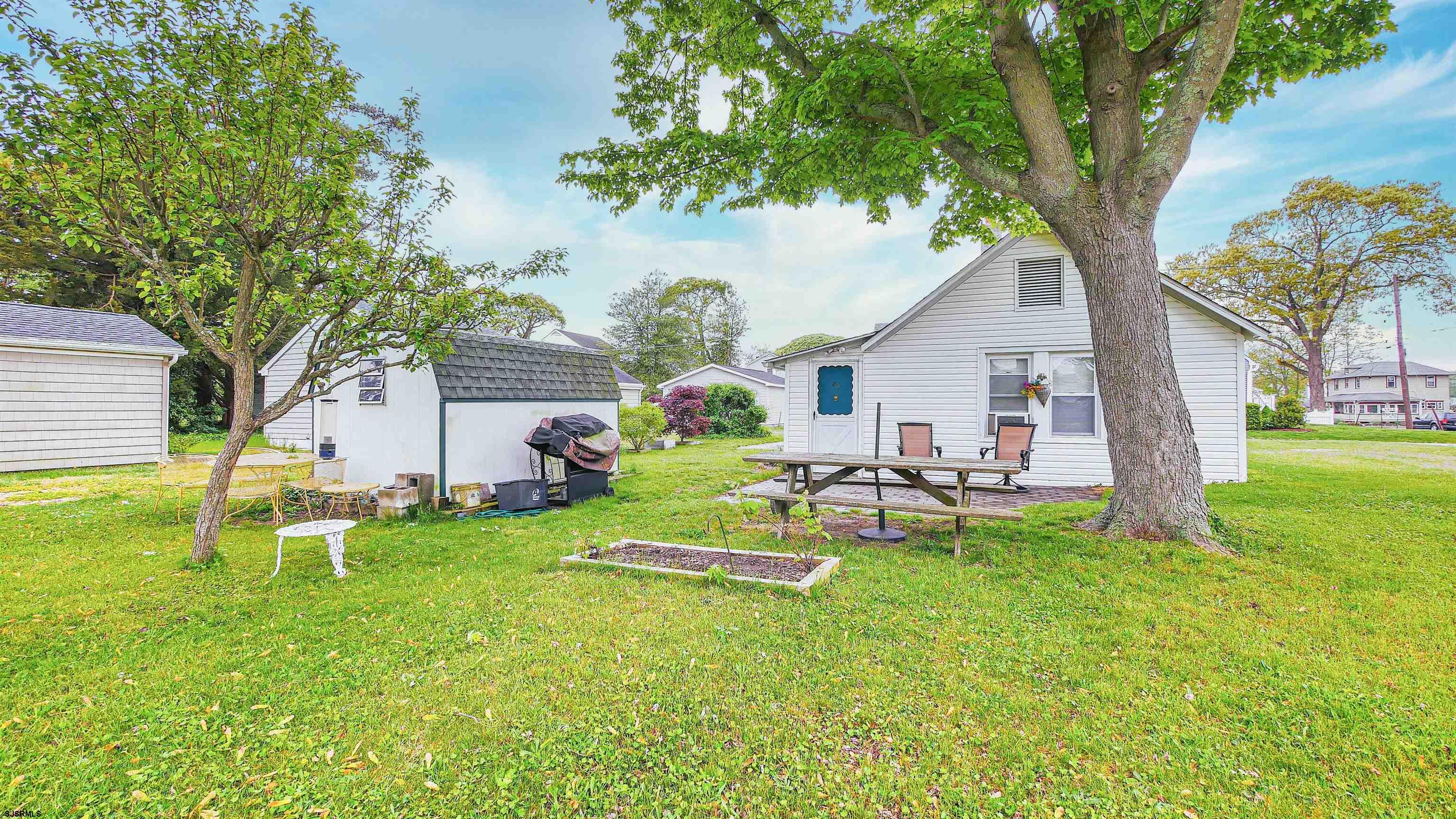 a view of a house with a backyard and a patio