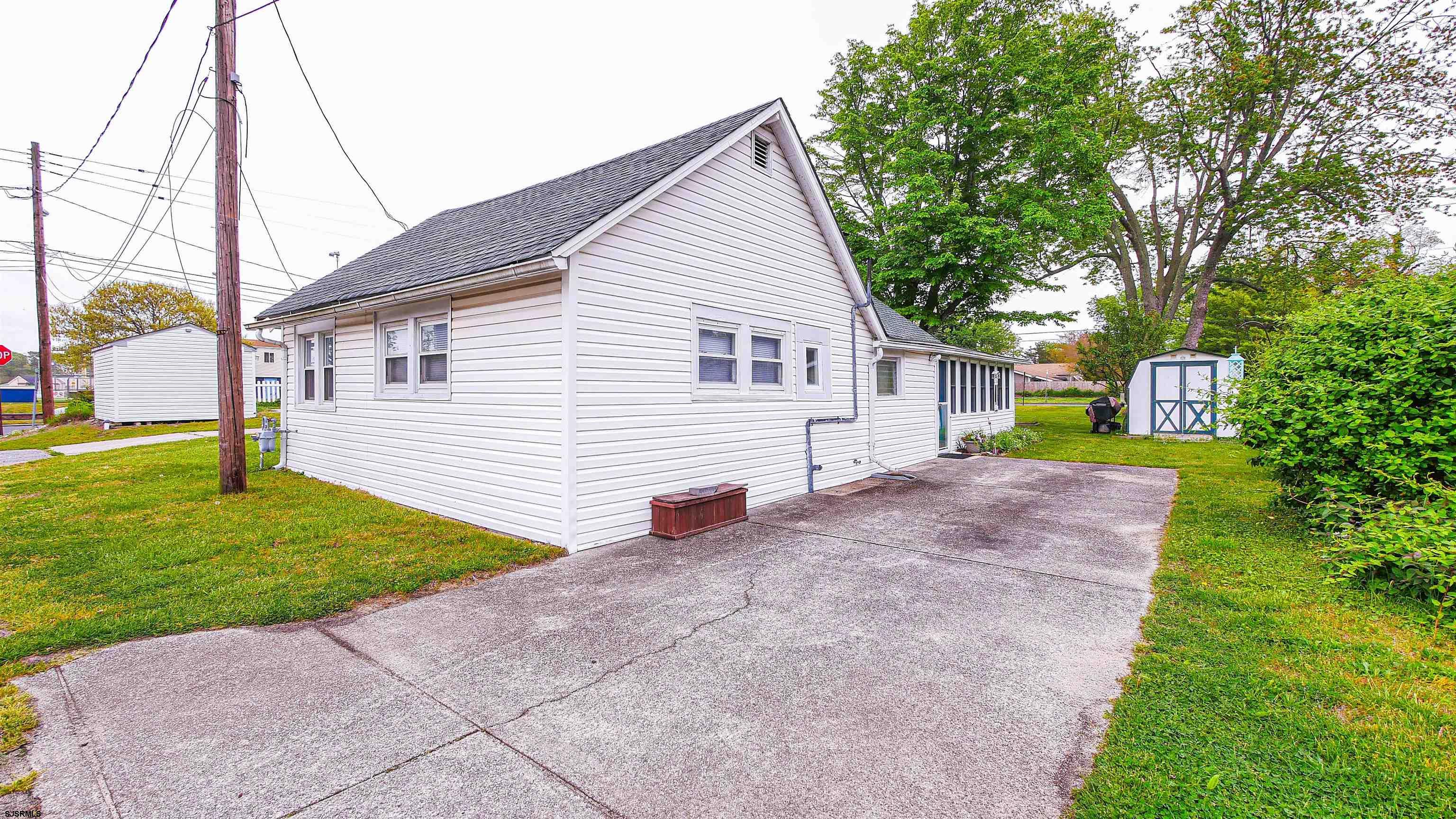 605 1st Street Somers Point, NJ 08244 - Photo 12 of 33 a view of a house with a yard and a garage