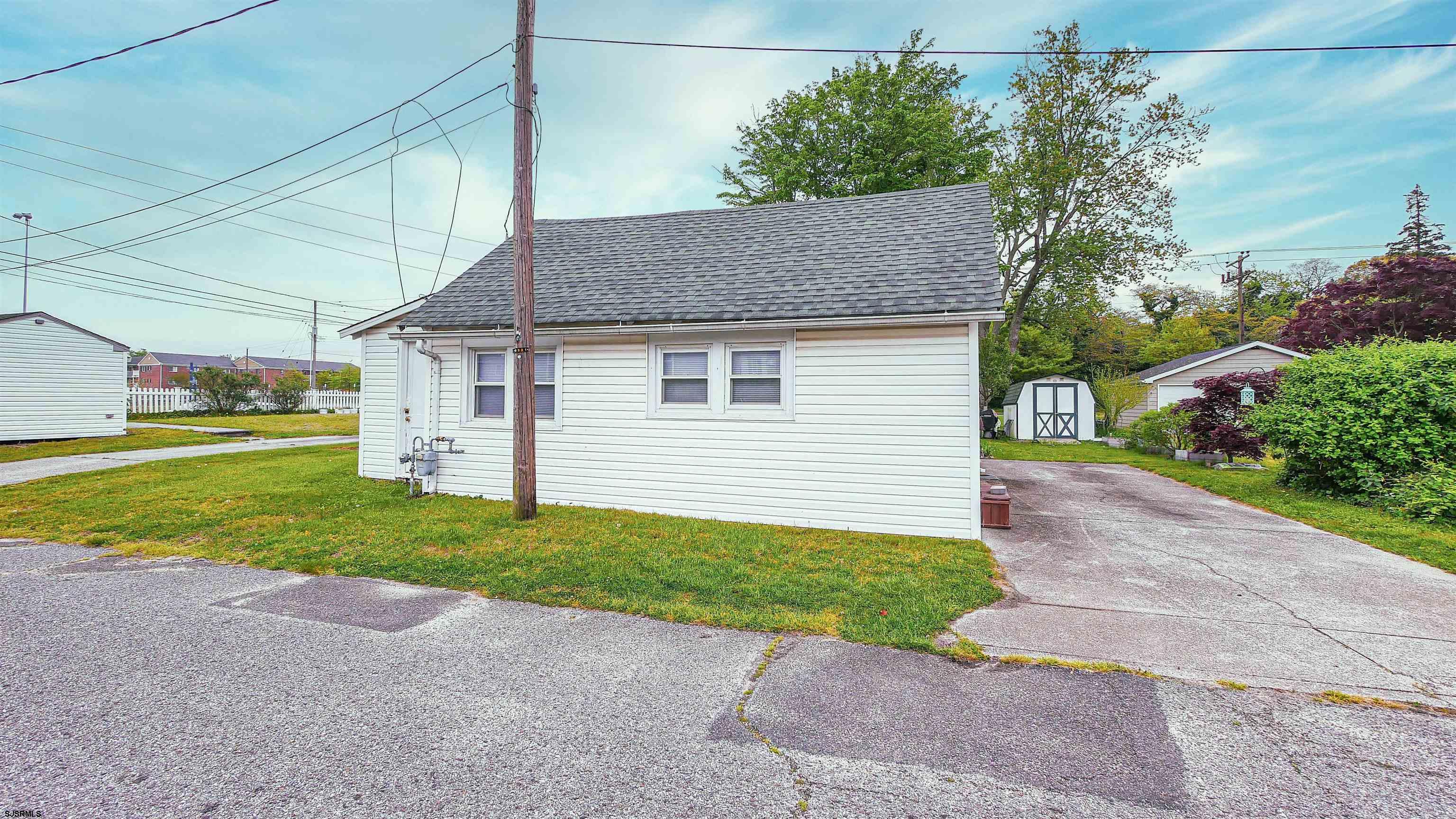 605 1st Street Somers Point, NJ 08244 - Photo 13 of 33 a front view of a house with a yard and garage