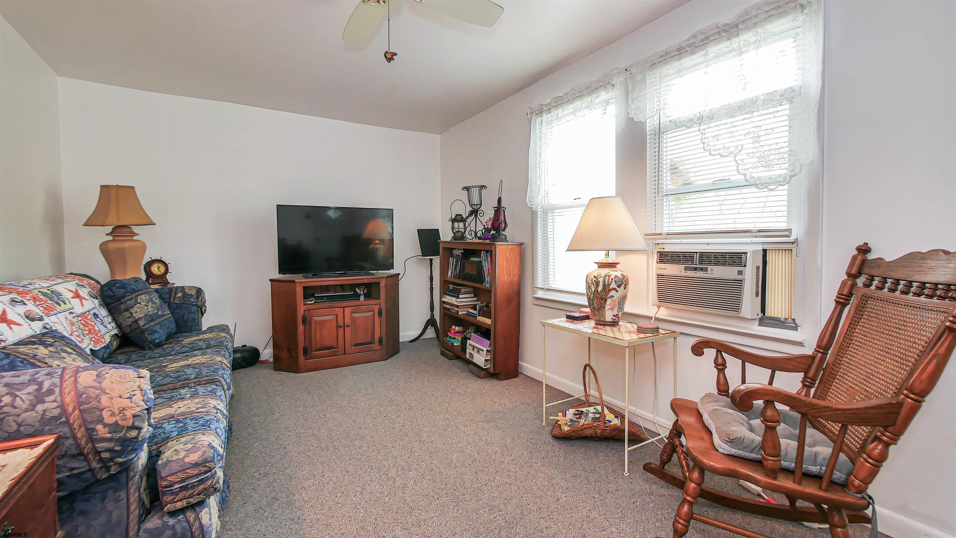 605 1st Street Somers Point, NJ 08244 - Photo 18 of 33 a living room with furniture a flat screen tv and a window
