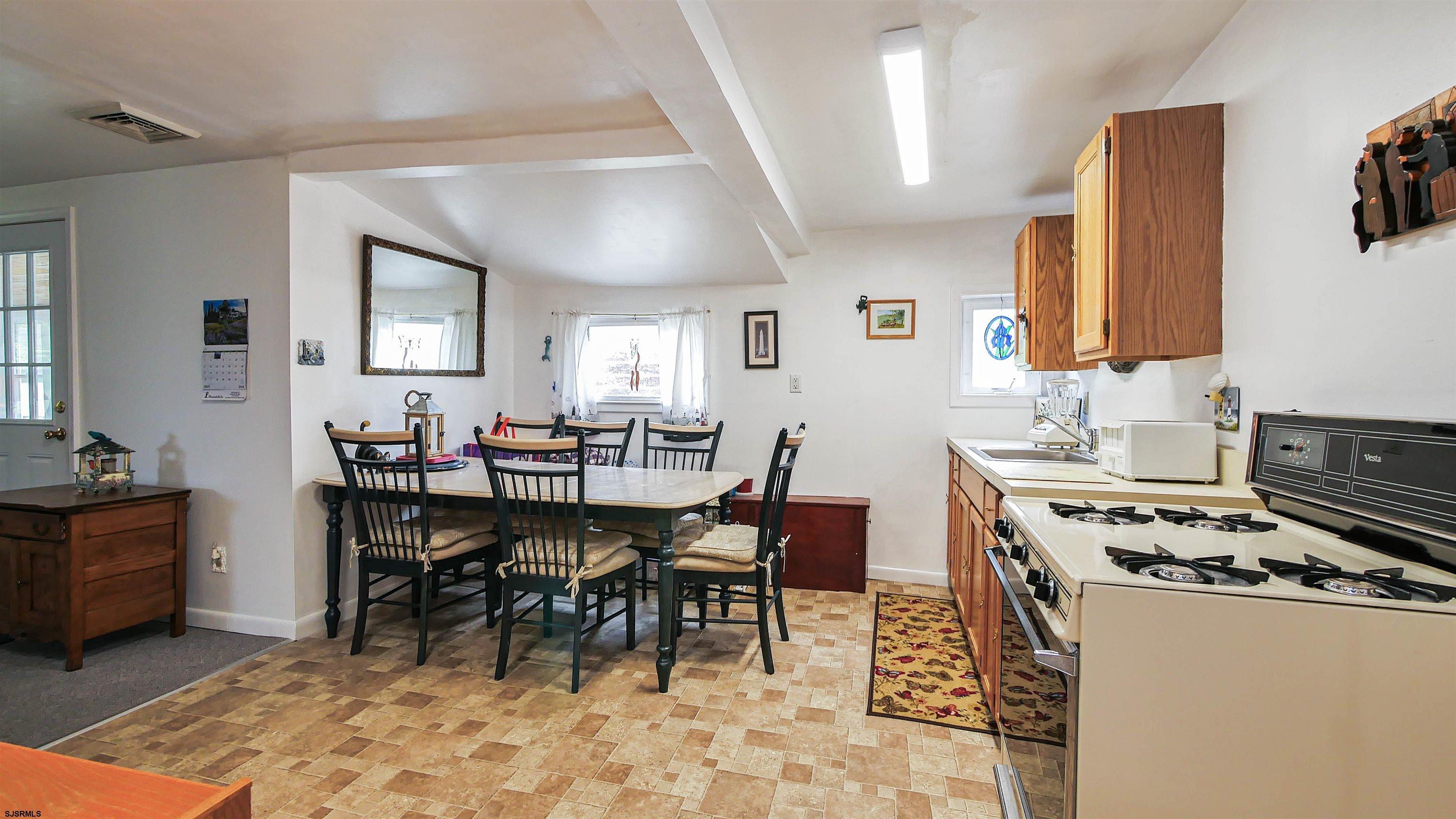 605 1st Street Somers Point, NJ 08244 - Photo 23 of 33 a kitchen with a dining table and chairs