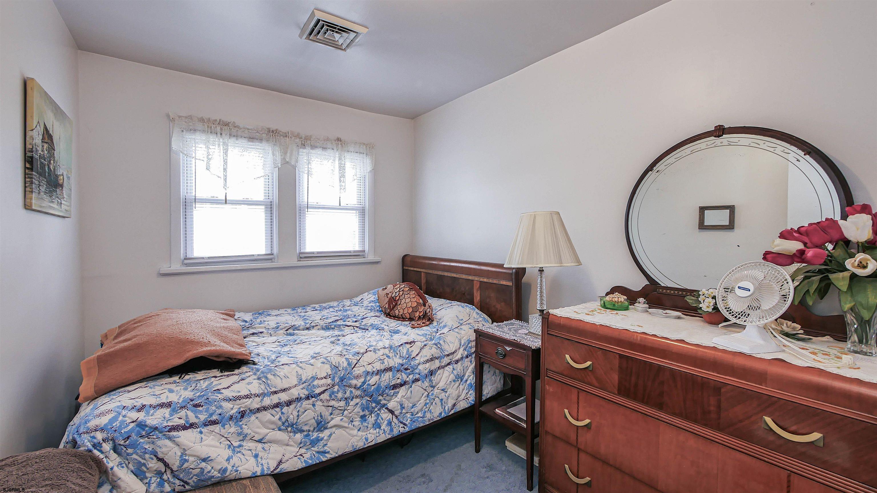 605 1st Street Somers Point, NJ 08244 - Photo 27 of 33 a bedroom with a bed and a dresser
