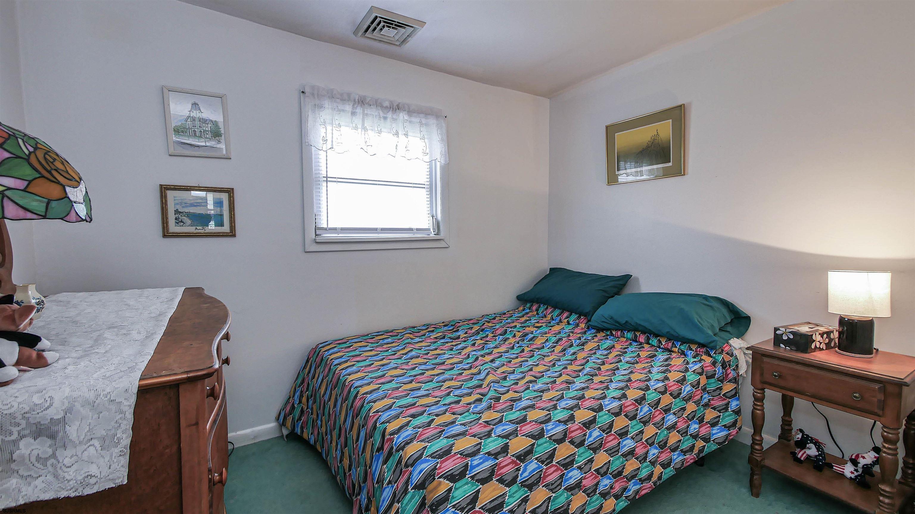605 1st Street Somers Point, NJ 08244 - Photo 28 of 33 a bedroom with a bed and a dresser in it