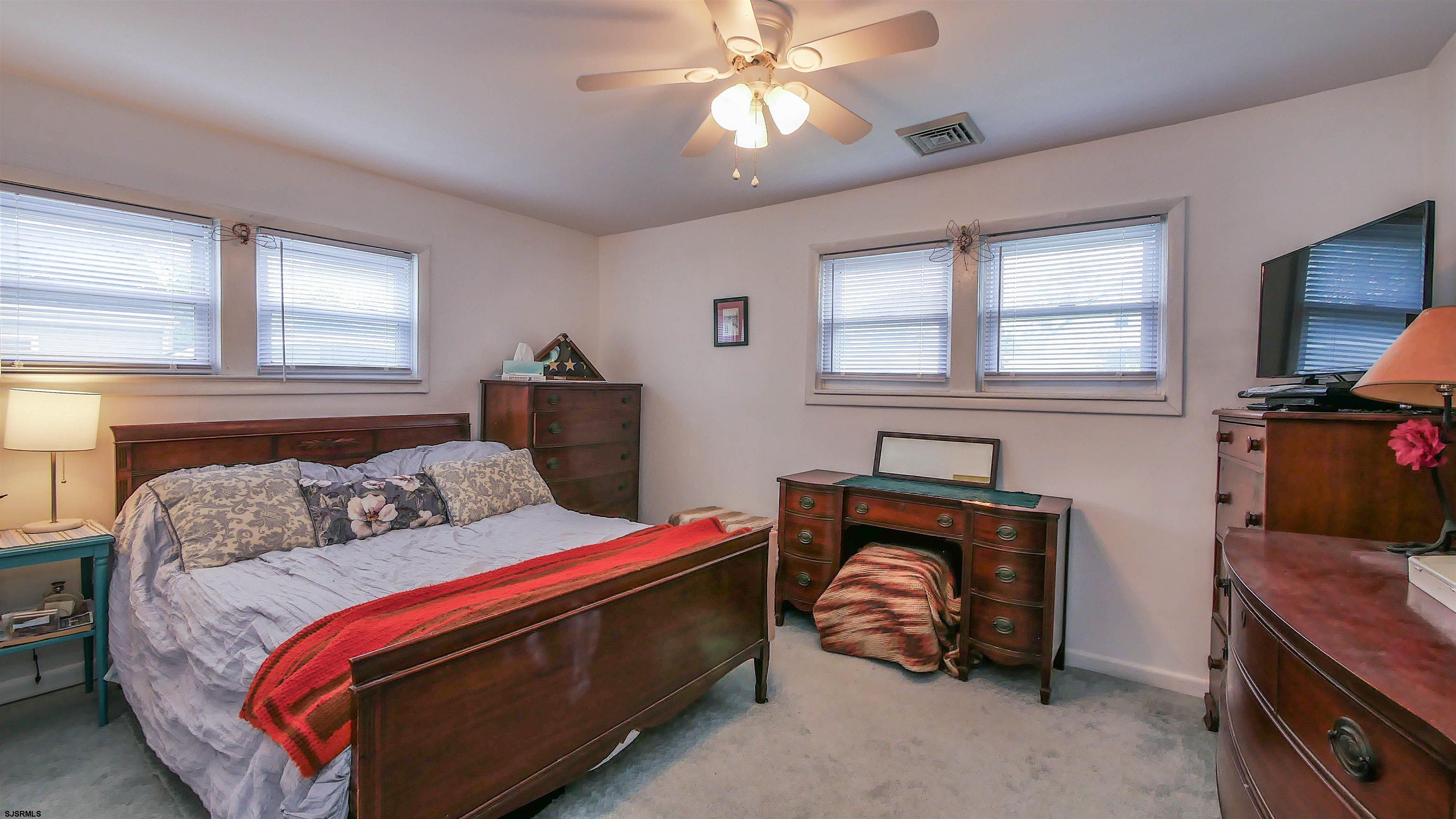 605 1st Street Somers Point, NJ 08244 - Photo 29 of 33 a bedroom with a bed and a tv