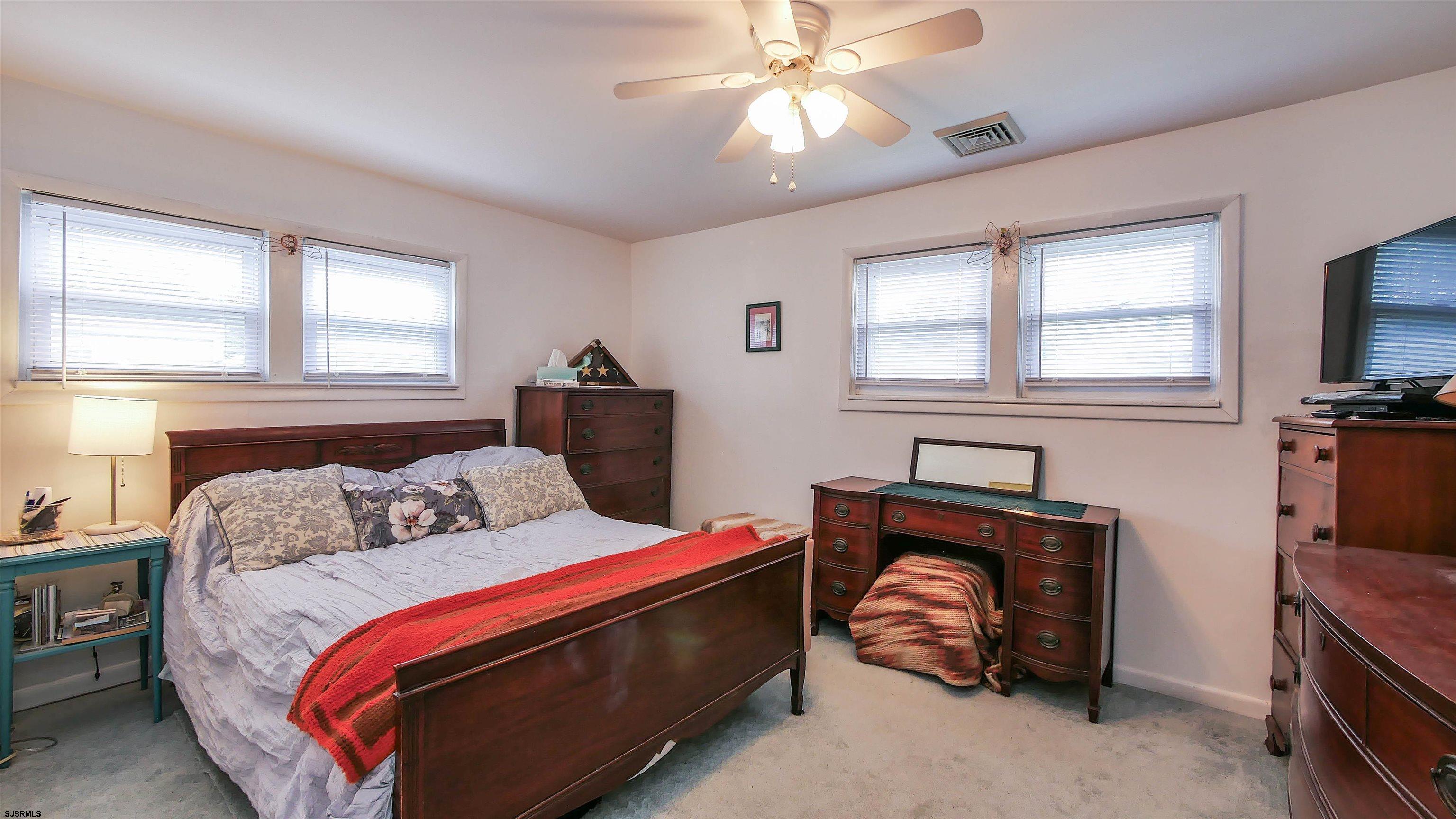 605 1st Street Somers Point, NJ 08244 - Photo 30 of 33 a bedroom with a bed and a chandelier