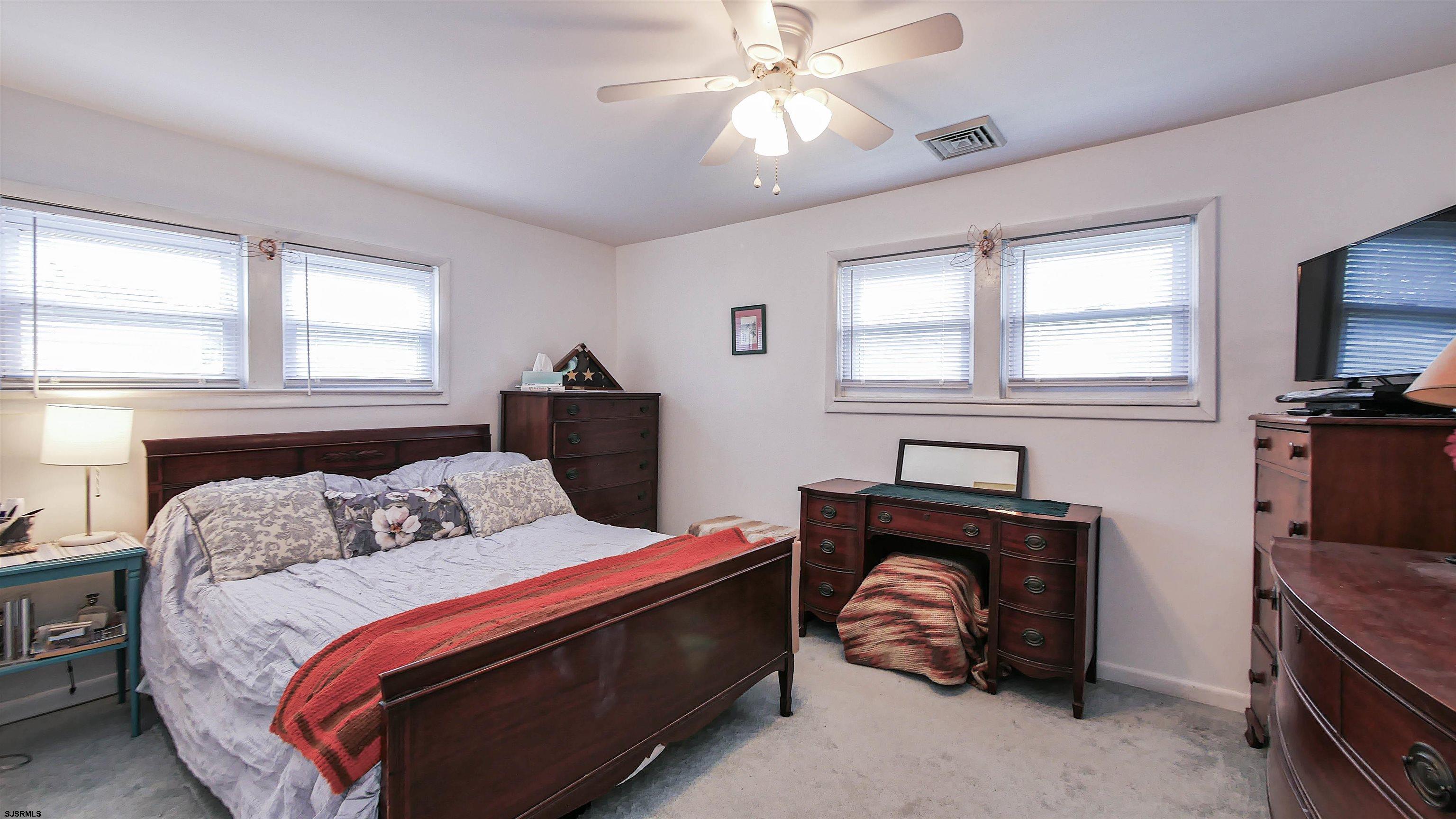 605 1st Street Somers Point, NJ 08244 - Photo 31 of 33 a bedroom with a bed and a chandelier