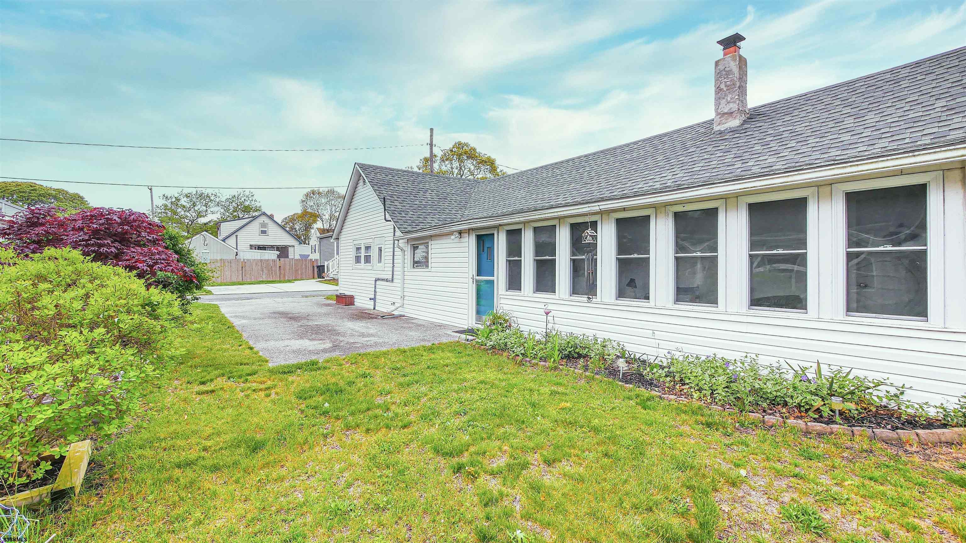 605 1st Street Somers Point, NJ 08244 - Photo 7 of 33 a view of a house with a small yard and plants
