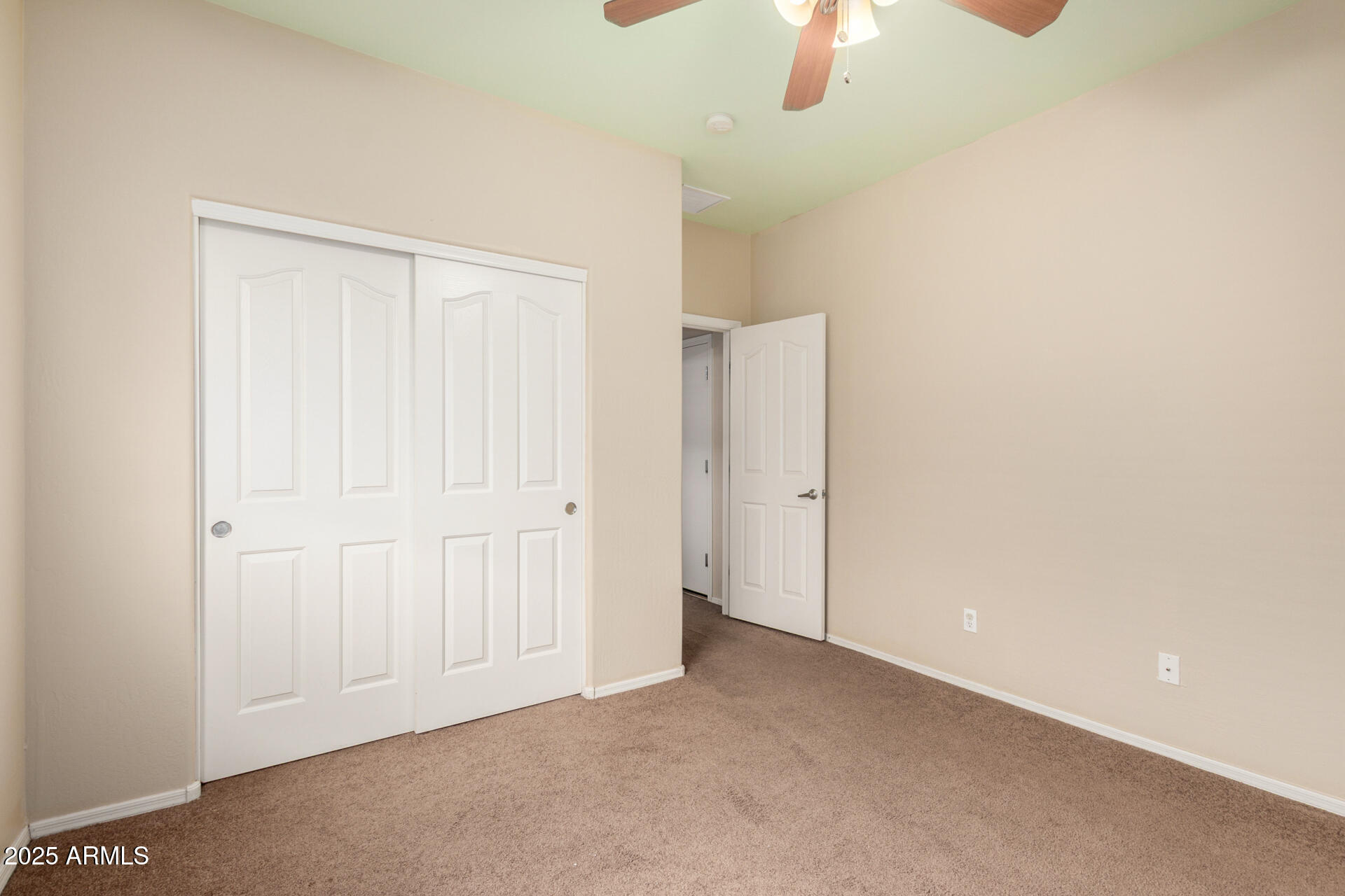 3908 East Minton Street Phoenix, AZ 85042 - Photo 21 of 31 an empty room with a ceiling fan window and a chandelier fan
