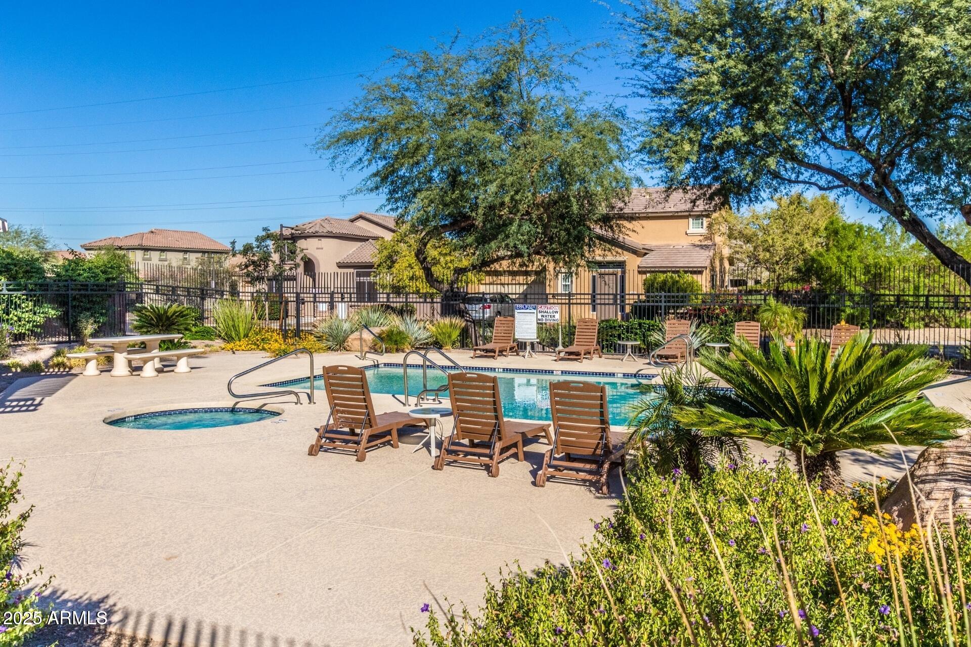 3908 East Minton Street Phoenix, AZ 85042 - Photo 6 of 31 a view of a patio with table and chairs under an umbrella