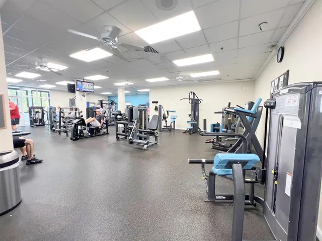 a living room with lots of furniture and a chandelier
