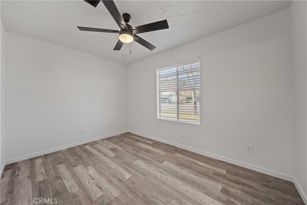 40054 Ridgemist Street Palmdale, CA 93591 - Photo 18 of 21 an empty room with ceiling fan and windows