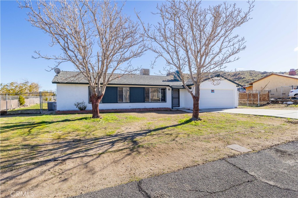 40054 Ridgemist Street Palmdale, CA 93591 - Photo 2 of 21 a house with a swimming pool and large trees