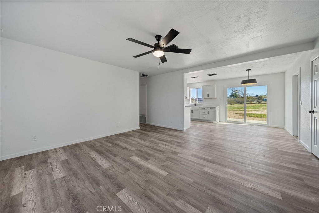 40054 Ridgemist Street Palmdale, CA 93591 - Photo 4 of 21 wooden floor in an empty room with a window