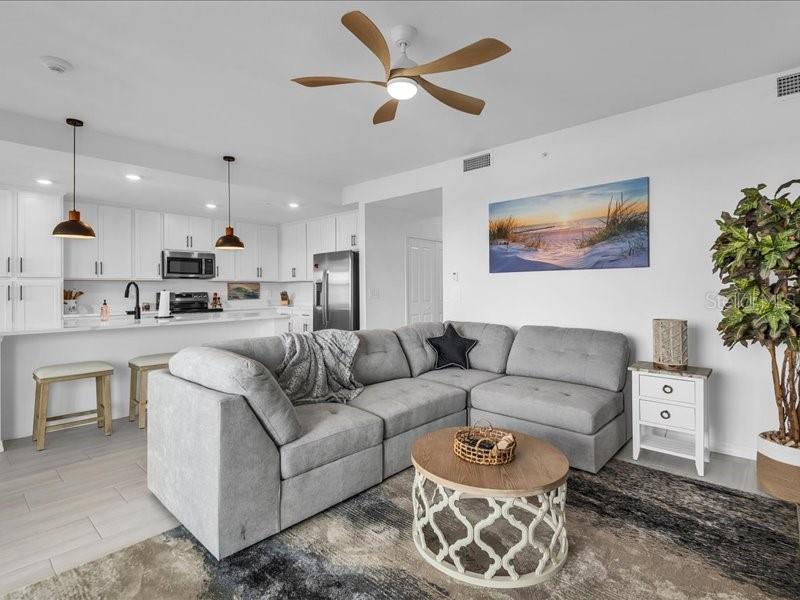 19116 Scallop Loop, Unit 303 Lakewood Ranch, FL 34211 - Photo 17 of 32 a living room with furniture kitchen view and a potted plant