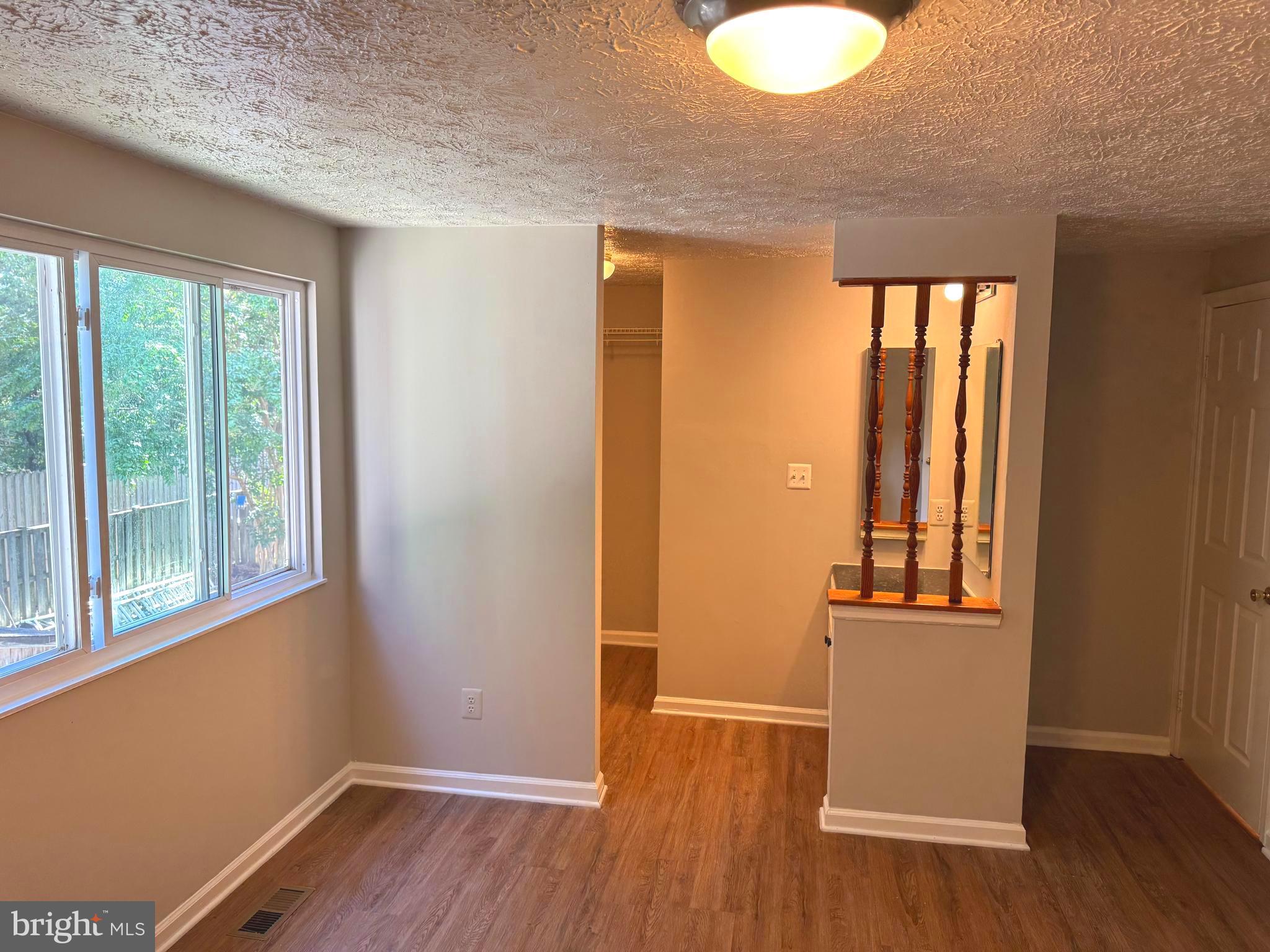 3615 Wharf Lane Triangle, VA 22172 - Photo 11 of 23 an empty room with wooden floor and windows