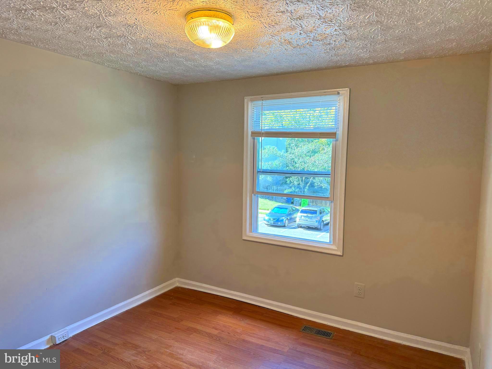 3615 Wharf Lane Triangle, VA 22172 - Photo 12 of 23 an empty room with wooden floor and windows