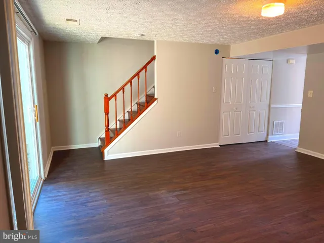 a view of an entryway with wooden floor