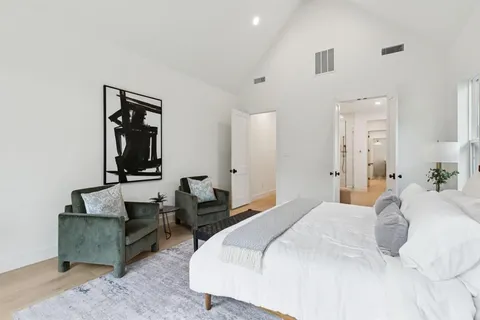 a bedroom with bed and a couch