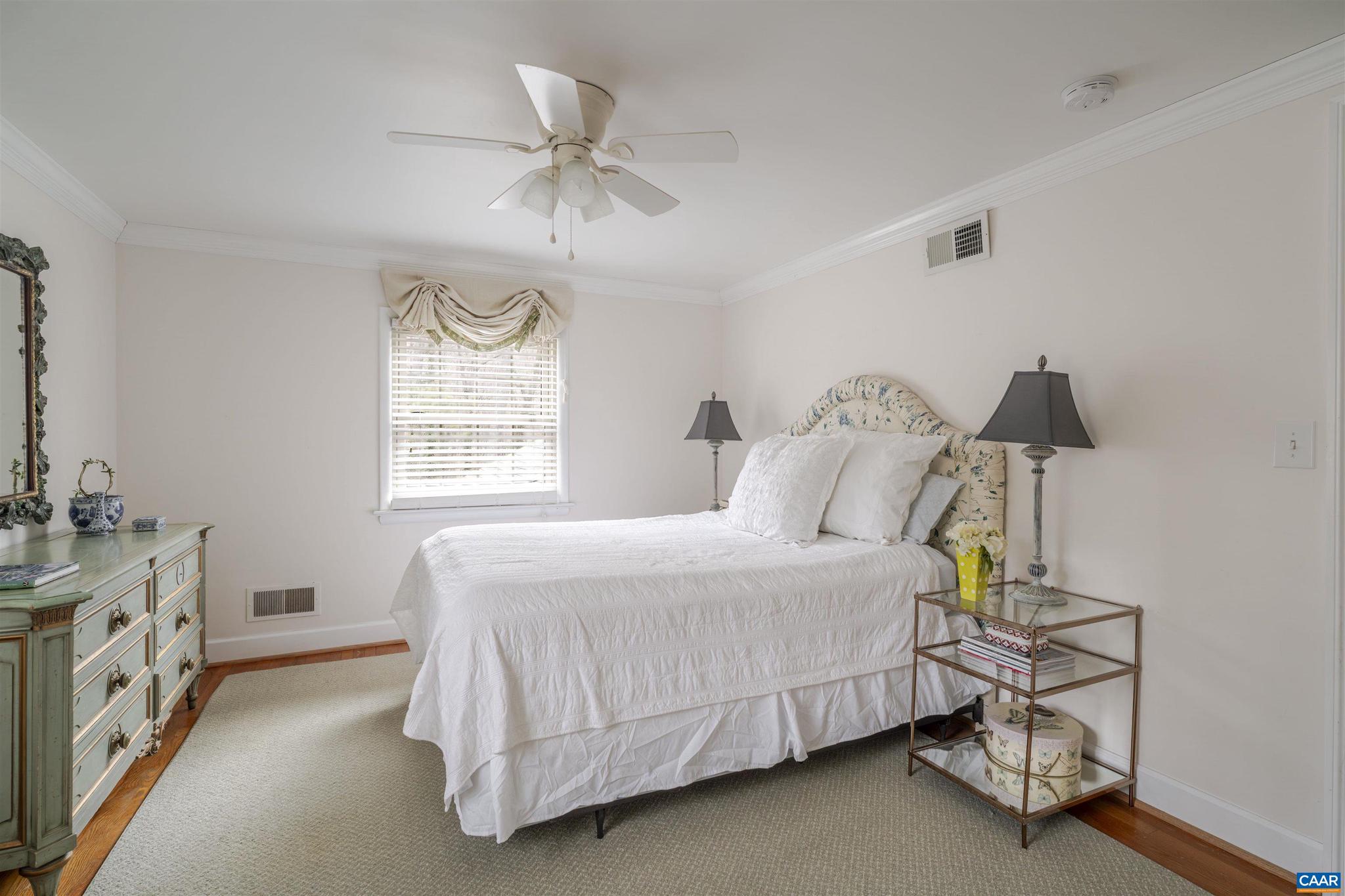 21 Deer Path Charlottesville, VA 22903 - Photo 21 of 27 a bedroom with a bed and a chandelier