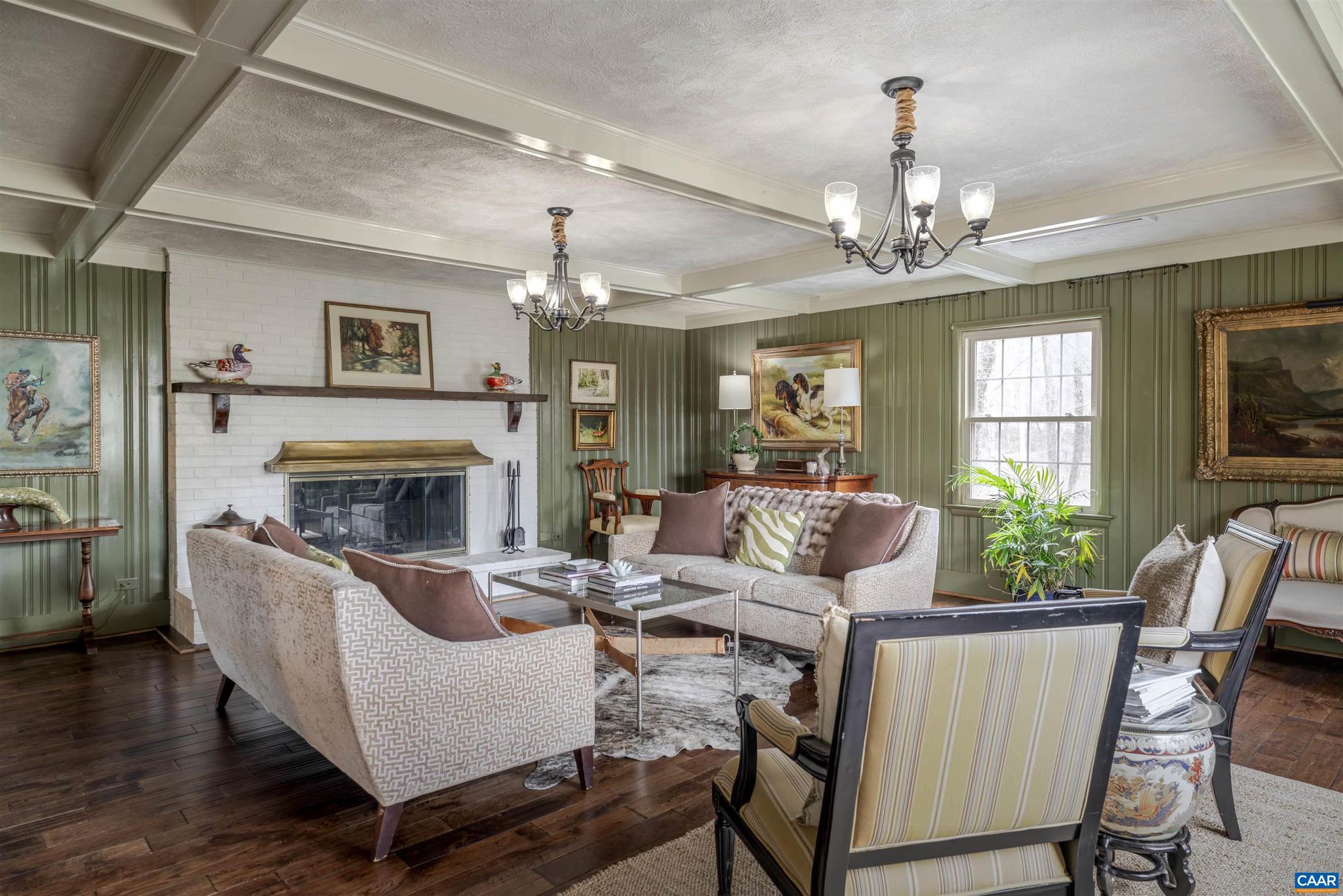 21 Deer Path Charlottesville, VA 22903 - Photo 6 of 27 a living room with furniture a chandelier and a fireplace