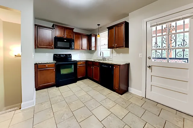 a kitchen with stainless steel appliances granite countertop a refrigerator and a stove top oven
