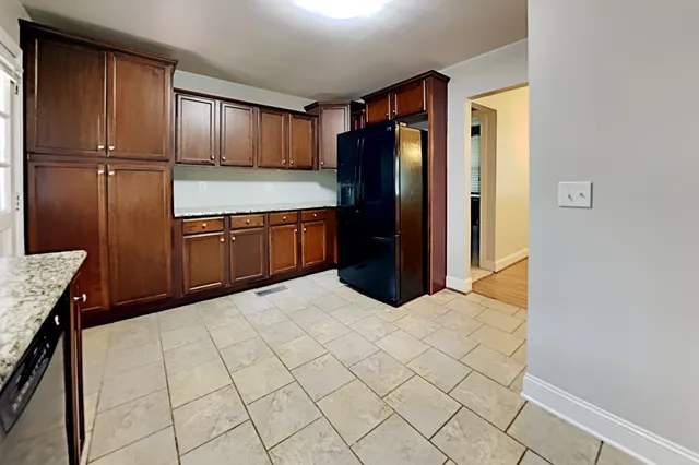 a kitchen with stainless steel appliances a refrigerator and cabinets