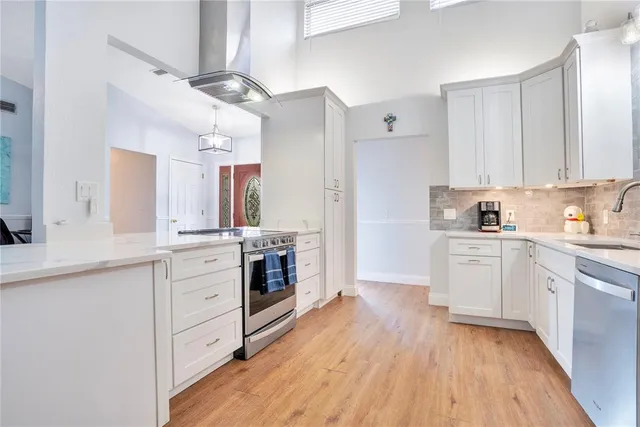 a kitchen with white cabinets and white appliances