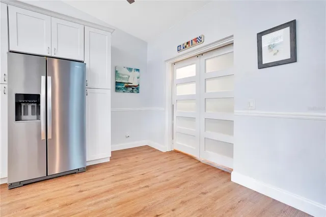 a view of empty room with wooden floor and closet