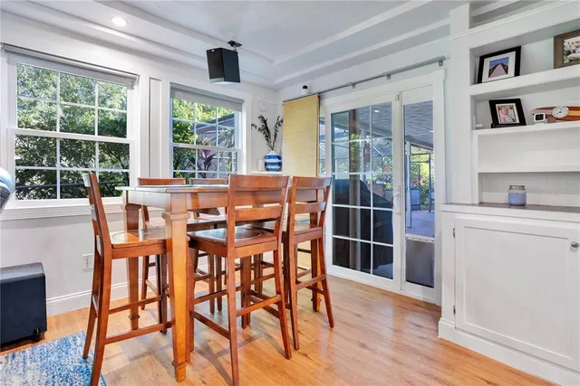 a dining room with furniture and wooden floor