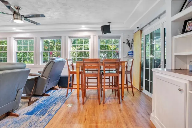 a view of a dining room with furniture windows and wooden floor