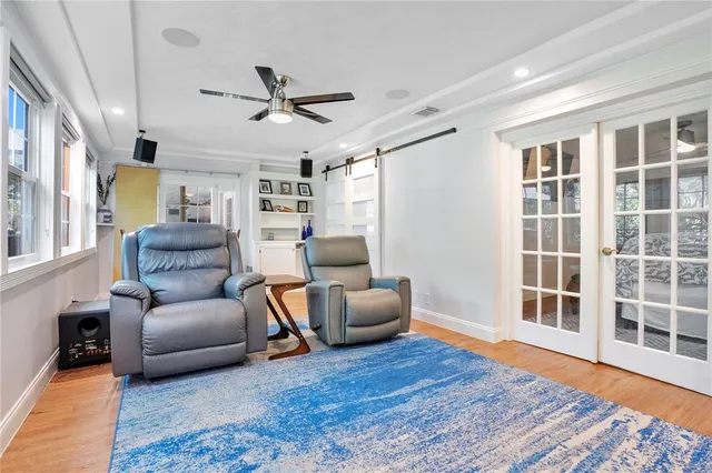 a living room with furniture and a wooden floor