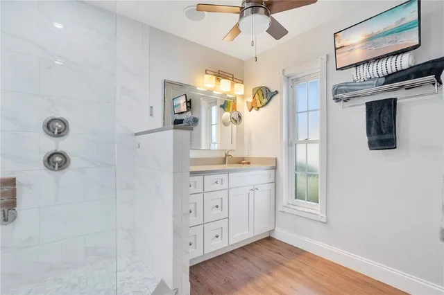 a spacious bathroom with a granite countertop sink mirror and shower