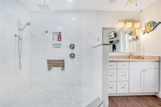 a bathroom with a granite countertop sink a shower and a mirror